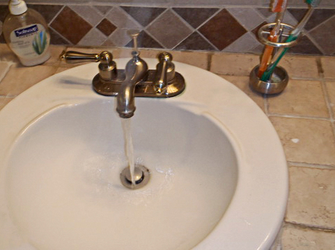 bathroom sink, cold water running